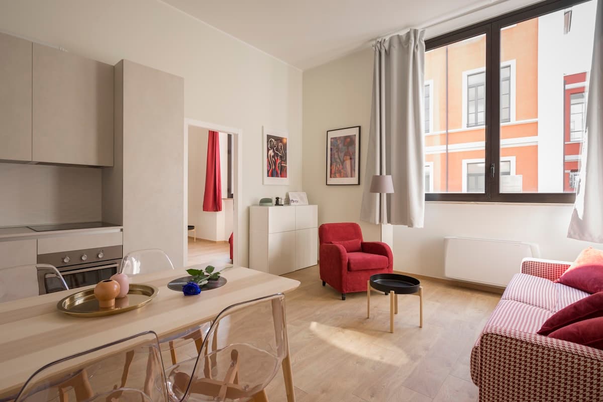 Bright furnished flat with a red armchair