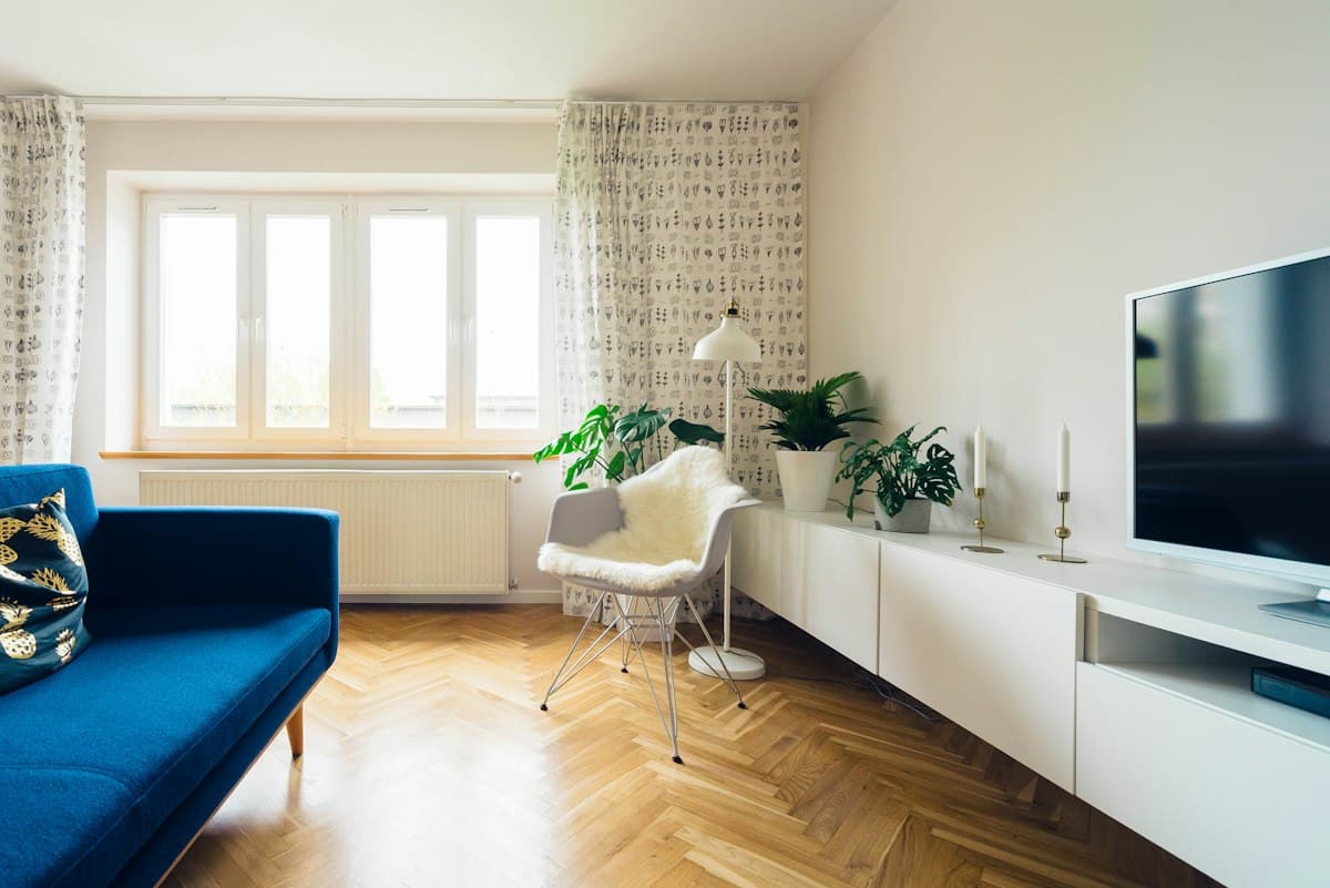 Living room with a blue sofa and herringbone floor